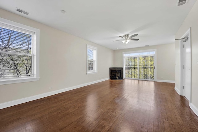 4538 S Calumet Ave Unit 3N, Chicago, IL 60653 - unfurnished living room with a fireplace, a ceiling fan, visible vents, and a healthy amount of sunlight