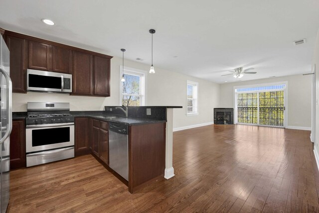 4538 S Calumet Ave Unit 3N, Chicago, IL 60653 - kitchen with ceiling fan, visible vents, stainless steel appliances, dark wood-style flooring, and a peninsula
