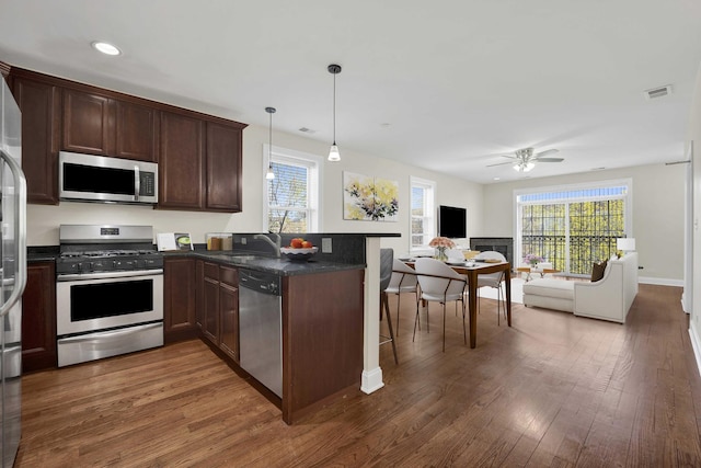 4538 S Calumet Ave Unit 3N, Chicago, IL 60653 - kitchen with wood finished floors, appliances with stainless steel finishes, visible vents, a ceiling fan, and open floor plan