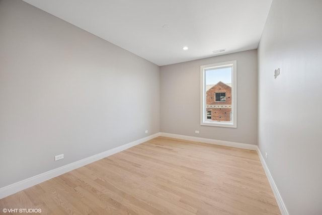 unfurnished room with baseboards, recessed lighting, and light wood-style floors