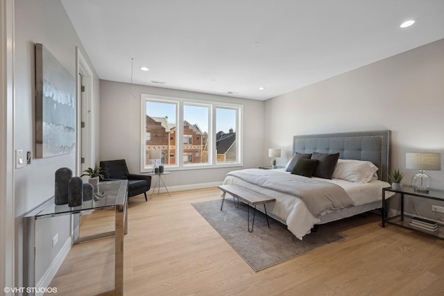 bedroom featuring baseboards, light wood-style floors, and recessed lighting