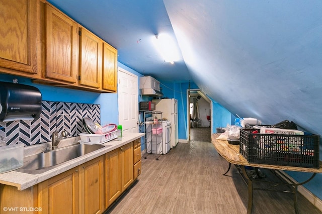 8119 S Escanaba Ave, Chicago, IL 60617 - kitchen with vaulted ceiling, light countertops, light wood-style flooring, tasteful backsplash, and gas range gas stove