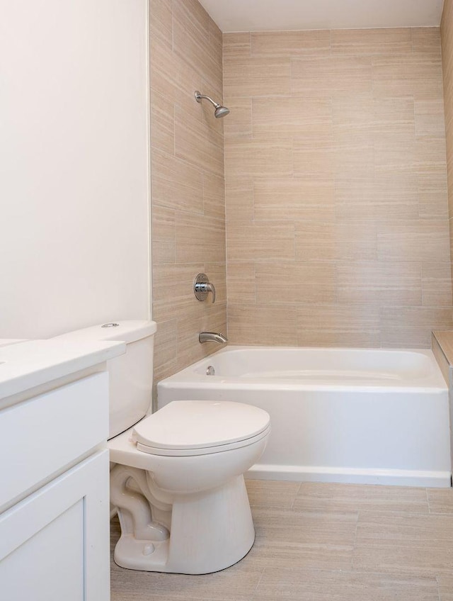 full bath featuring washtub / shower combination, toilet, and vanity