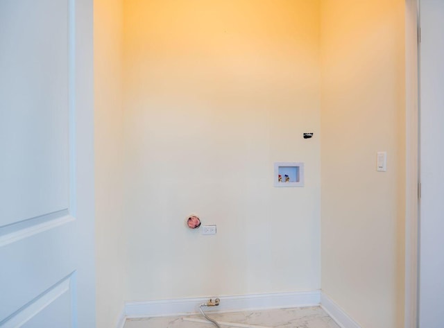 washroom featuring marble finish floor, hookup for a washing machine, baseboards, and laundry area