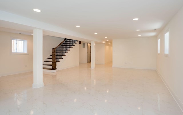 basement featuring stairway, marble finish floor, baseboards, and recessed lighting