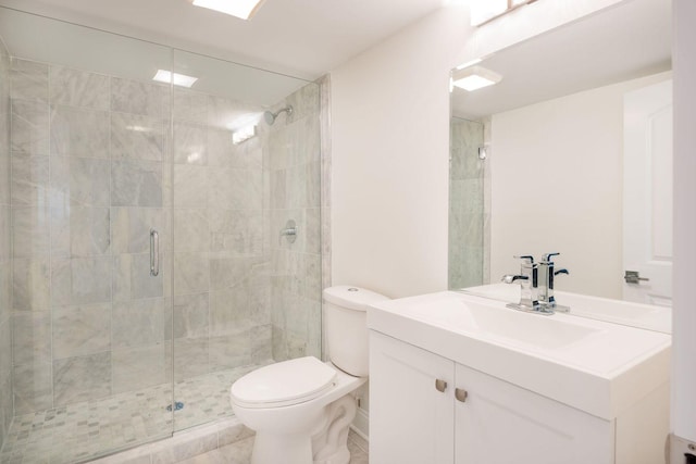 full bath with toilet, vanity, and a stall shower