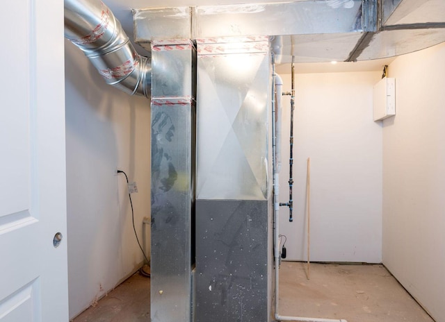 utility room featuring heating unit
