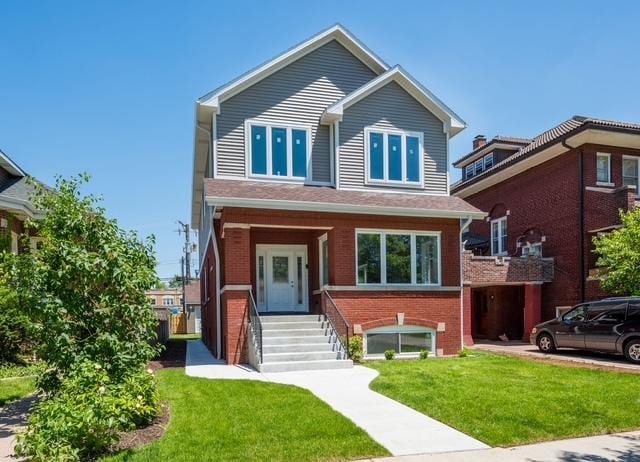 view of front of house featuring brick siding and a front lawn