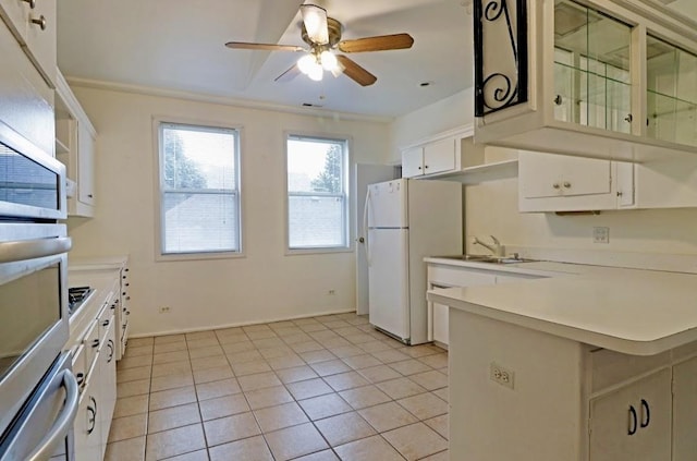 1811 Emerson St, Evanston, IL 60201 - kitchen featuring a ceiling fan, a sink, freestanding refrigerator, a peninsula, and stainless steel oven