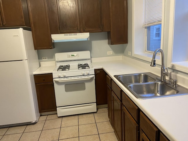 1811 Emerson St, Evanston, IL 60201 - kitchen with dark brown cabinets, a sink, white appliances, light tile patterned floors, and exhaust hood
