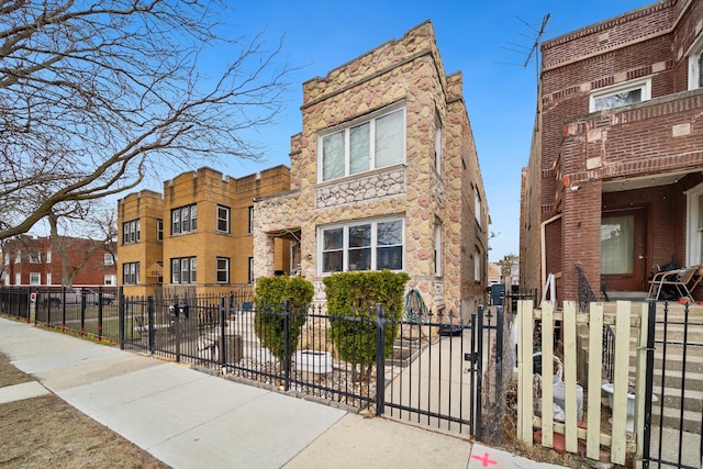 view of building exterior with a fenced front yard