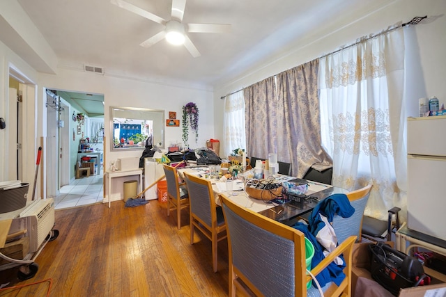 dining room featuring ceiling fan, wood-type flooring, and visible vents