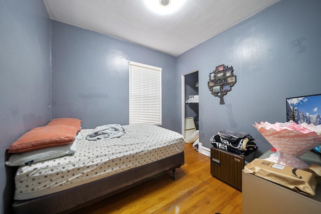 bedroom featuring baseboards and light wood finished floors