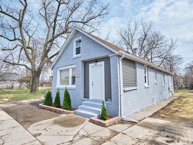 14923 Wood St, Harvey, IL 60426 - bungalow-style house with a chimney, entry steps, and brick siding