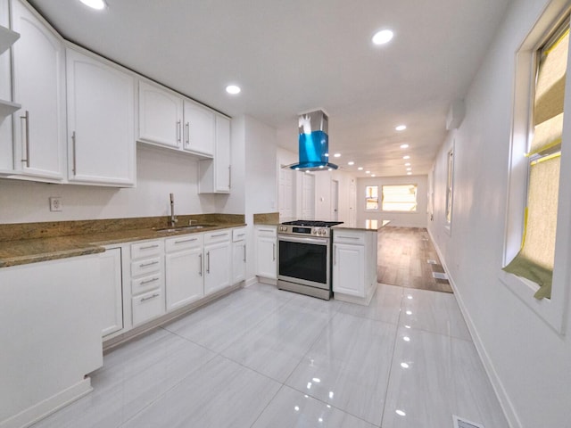 14923 Wood St, Harvey, IL 60426 - kitchen featuring white cabinets, island exhaust hood, a sink, and stainless steel gas range oven