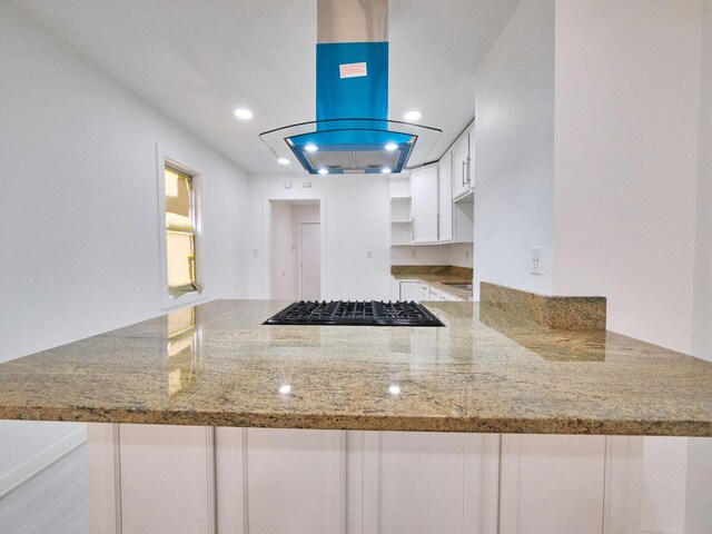 14923 Wood St, Harvey, IL 60426 - kitchen featuring light stone counters, island range hood, a peninsula, white cabinetry, and black gas stovetop