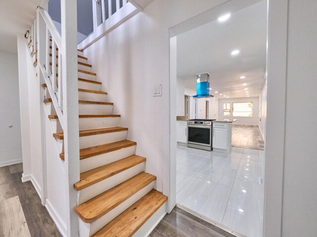 14923 Wood St, Harvey, IL 60426 - stairway featuring baseboards, wood finished floors, and recessed lighting