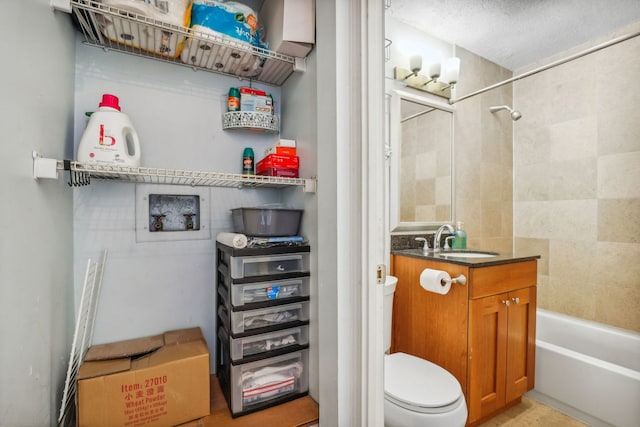 bathroom featuring vanity, shower / bathtub combination, and toilet