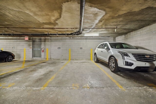 parking garage featuring concrete block wall