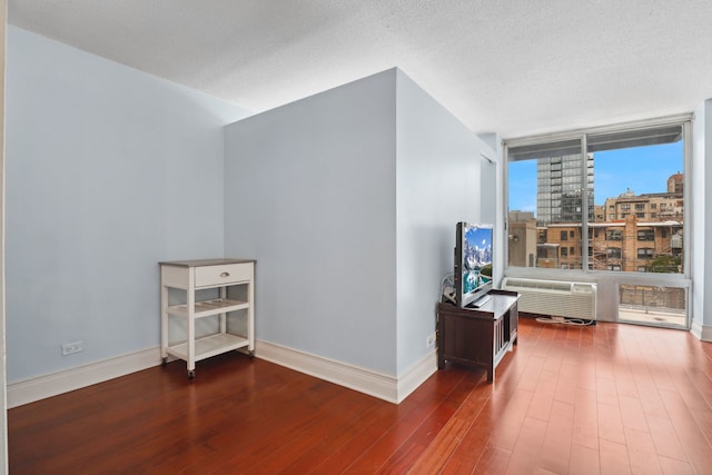 additional living space with baseboards and hardwood / wood-style floors
