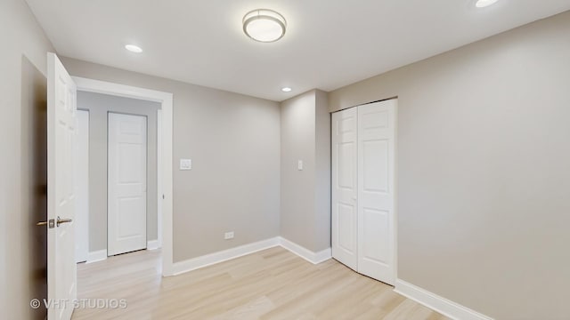 unfurnished bedroom featuring recessed lighting, baseboards, and light wood-type flooring
