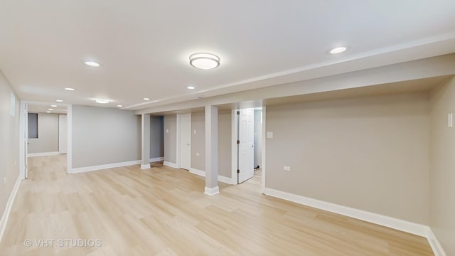 finished basement with recessed lighting, baseboards, and light wood-style flooring