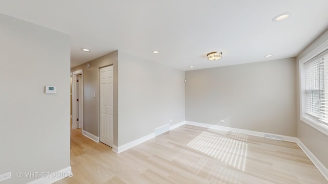 empty room with visible vents, recessed lighting, light wood finished floors, and baseboards