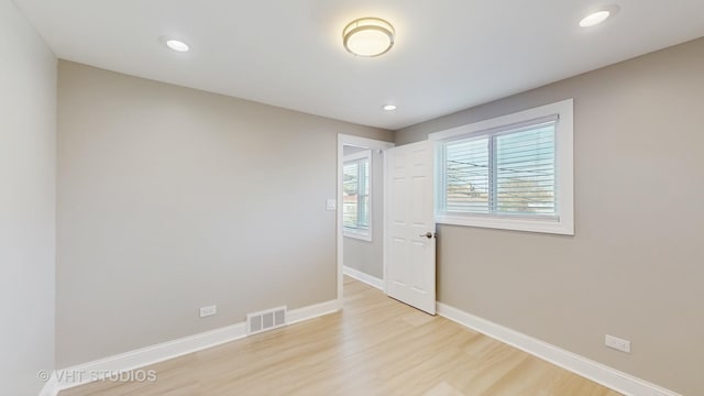 spare room with visible vents, recessed lighting, light wood-style flooring, and baseboards