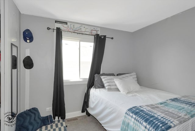 bedroom with visible vents and carpet