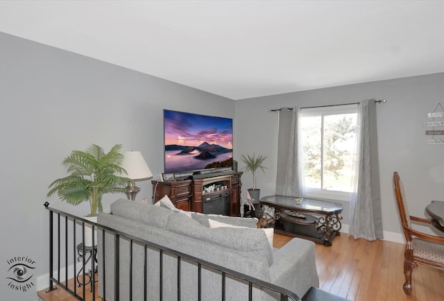 living room featuring baseboards and wood-type flooring