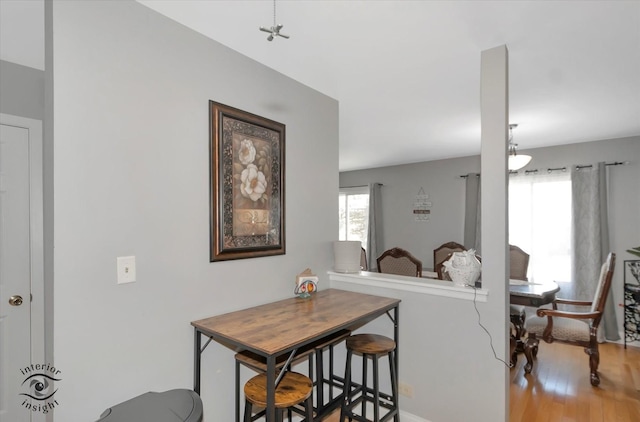 dining room with baseboards and light wood finished floors