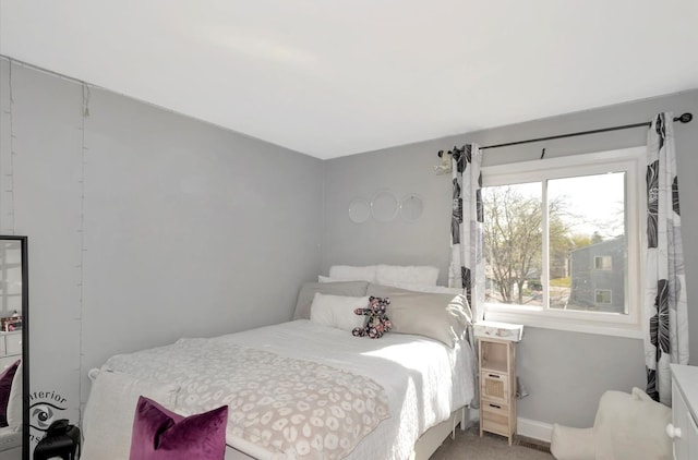 carpeted bedroom featuring baseboards
