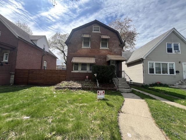 11916 S Harvard Ave, Chicago, IL 60628 - dutch colonial with a front lawn, fence, and brick siding