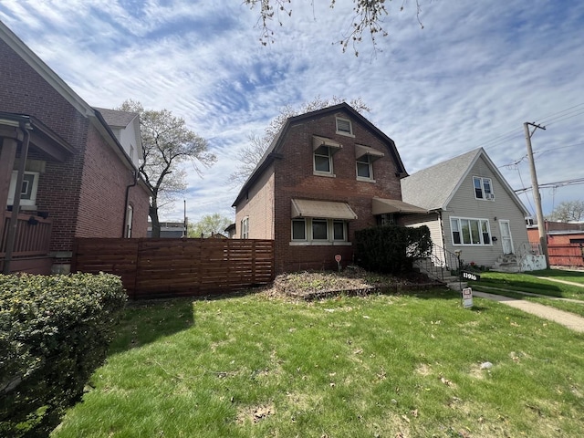 11916 S Harvard Ave, Chicago, IL 60628 - back of house featuring fence, a yard, and brick siding