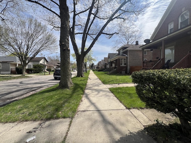 11916 S Harvard Ave, Chicago, IL 60628 - view of road with a residential view, sidewalks, and curbs