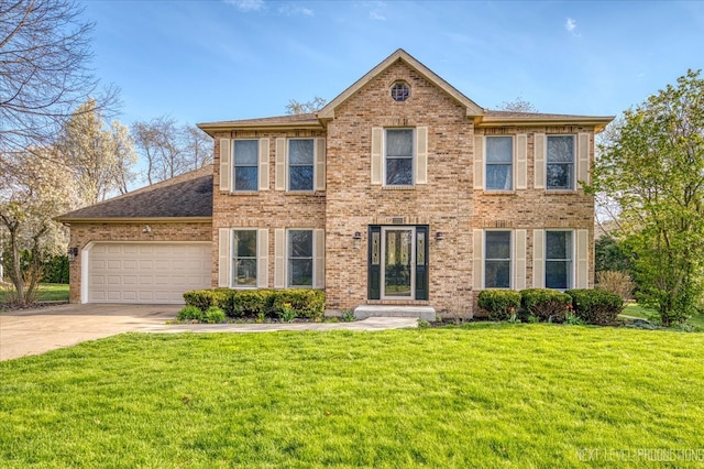 colonial house featuring an attached garage, brick siding, driveway, and a front yard
