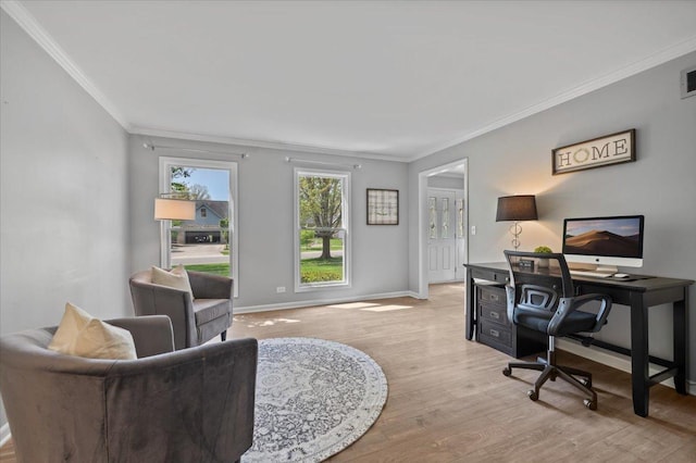 office featuring crown molding, baseboards, light wood finished floors, and visible vents