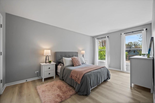bedroom with baseboards and light wood-style flooring