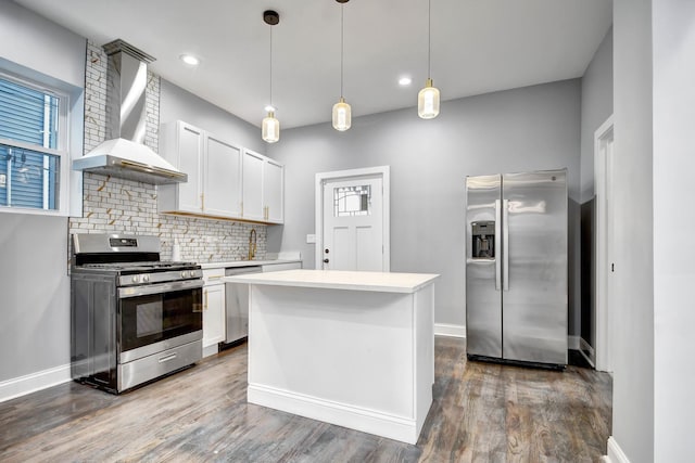 kitchen with stainless steel appliances, baseboards, decorative backsplash, wall chimney range hood, and light countertops