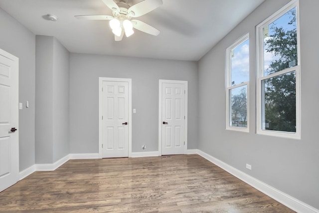 unfurnished bedroom featuring baseboards, a ceiling fan, and wood finished floors
