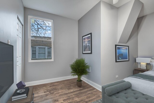 interior space featuring baseboards and wood finished floors