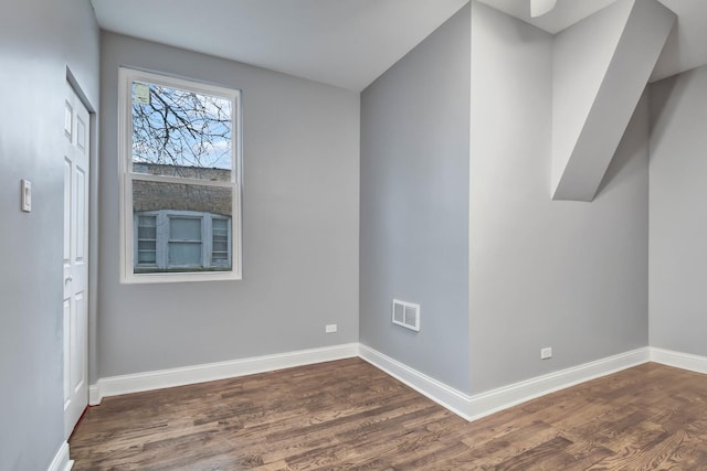 unfurnished room with dark wood finished floors, baseboards, and visible vents