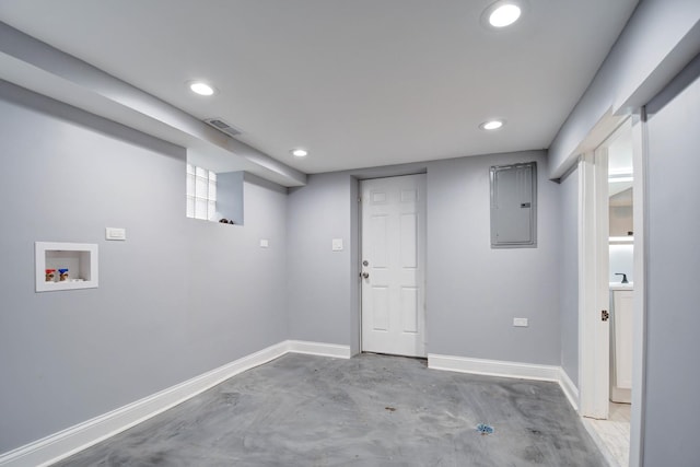 finished basement with baseboards, visible vents, electric panel, and recessed lighting
