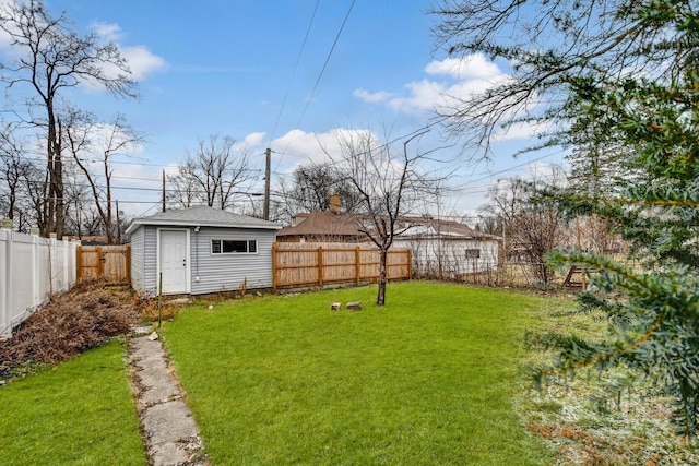 view of yard with a fenced backyard, an outdoor structure, and a storage shed