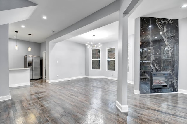 unfurnished living room featuring a fireplace, baseboards, recessed lighting, and dark wood-style flooring