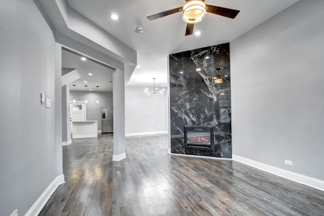 unfurnished living room with wood finished floors, ceiling fan, a premium fireplace, baseboards, and recessed lighting