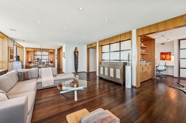 living room featuring recessed lighting, wood finished floors, visible vents, baseboards, and a notable chandelier