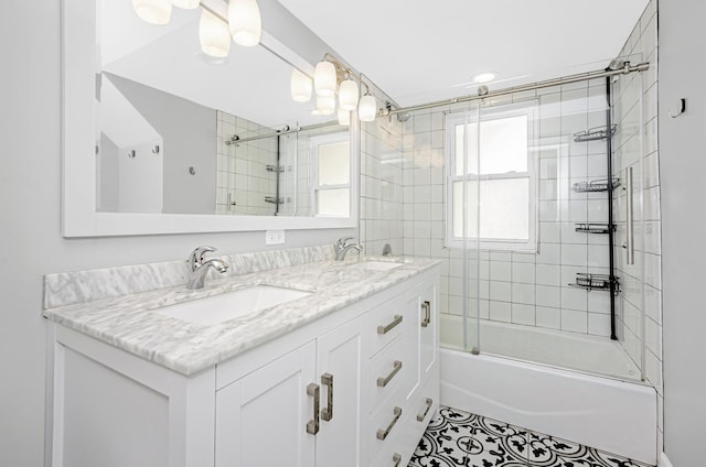 bathroom featuring double vanity, combined bath / shower with glass door, tile patterned floors, and a sink