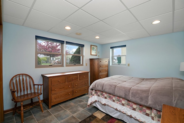bedroom featuring recessed lighting, a paneled ceiling, and dark tile patterned flooring