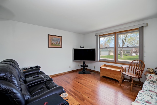 living room featuring baseboards and light wood-type flooring